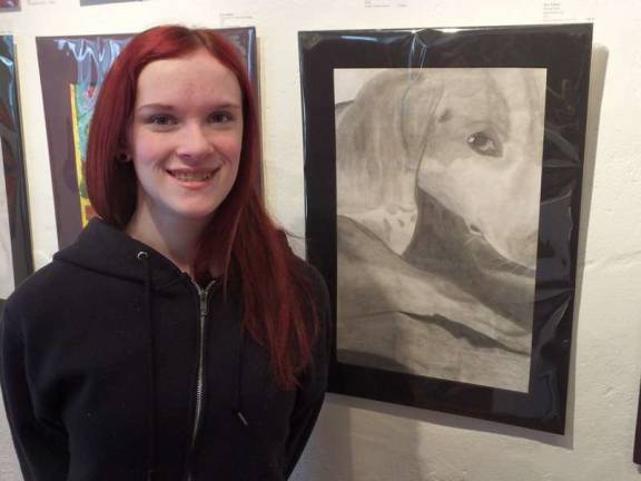 Kittatinny Regional High School artist Jessica Taylor next to her dog sketch. The portrait is of her pet beagle, Lily.