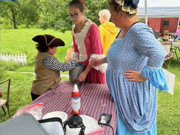 DR2 Ashley Ziccardi, right, demonstrates how ice cream was made back in the day. From left are Heath Ziccardi and Harmony Swanson.