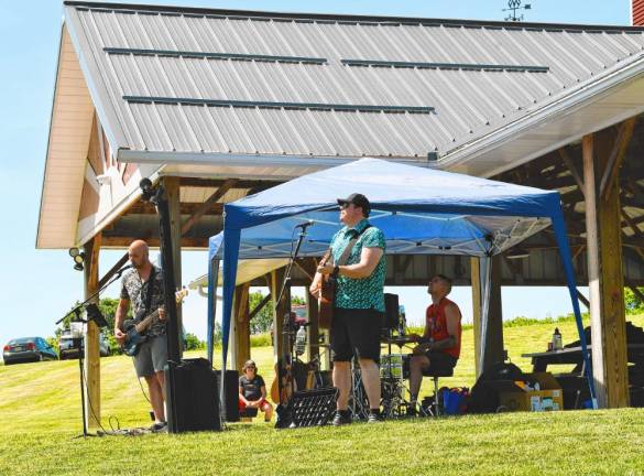 PS Xperiment performs at Wantage Day 2024 at Woodbourne Park. From left are J.P. on bass and lead vocals, Brian Shepherd on lead guitar and background vocals, and Chris Penn on drums. (Photo by Maria Kovic)