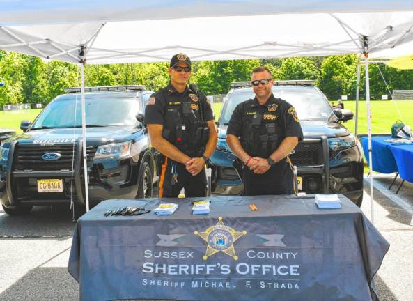 Robert Schilling and Robert Washer man a table for the Sussex County Sheriff’s Office at Wantage Day 2024. (Photo by Maria Kovic)