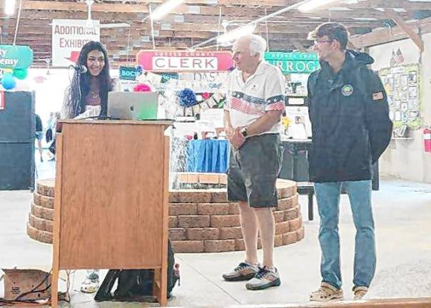 <b>Eighth-grader Amelia Mohabir, who received </b>a Young Historian award, describes how her teachers inspired her interest in history. <b>Sussex County historian Bill Truran, center, and county Commissioner Jack DeGroot listen. (Photo by Judy Perentin)</b>