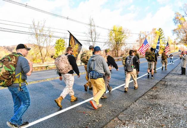 <b>Residents applaud the veterans marching through Vernon.</b>