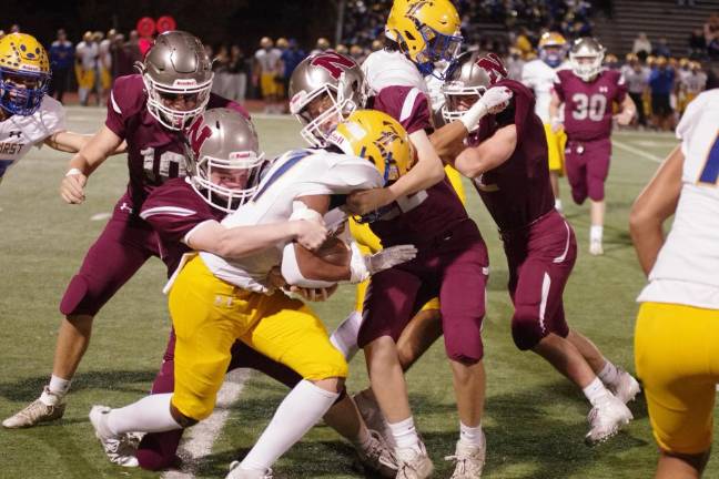 Newton defenders pounce on a Lyndhurst ball carrier.