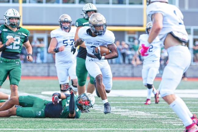 <b>Tylik Hill of Pope John looks to his left after breaking a tackle on a run from scrimmage in the first quarter of the game at Delbarton. (Photo by Glenn Clark)</b>