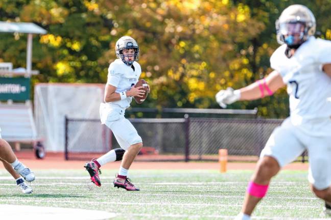 <b>Pope John quarterback Luke Irwin looks downfield at his receiver about to make a cut in to the Delbarton defense. (Photo by Glenn Clark)</b>