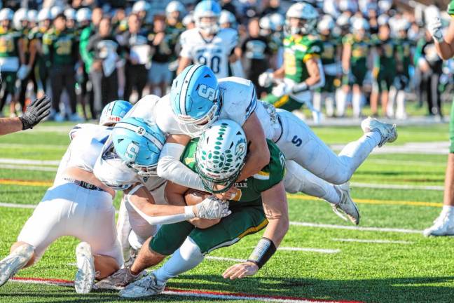 <b>Sparta’s Brill Lincoln and Brody Tanyeri come together to take down the Montville quarterback for a loss during first-quarter action. (Photo by Glenn Clark)</b>