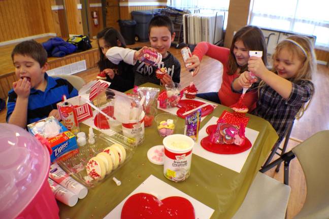 Children design cupcakes at the Barry Lakes Clubhouse on Monday.