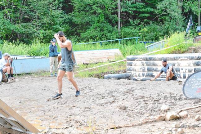 <b>Spartan Race competitors go through a series of deep water-filled mud pits.</b>