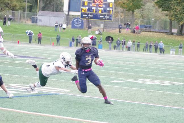 Pope John ball carrier Tylik Hill is on the move in the first half.