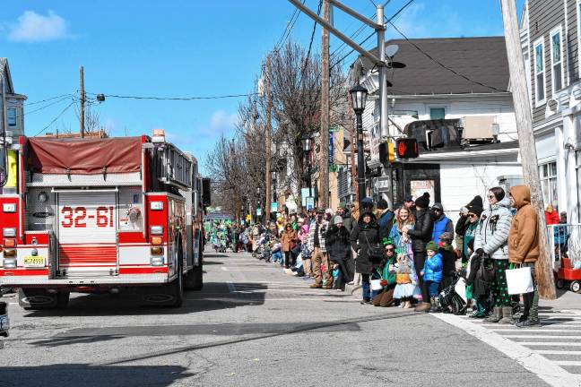 Parade-goers line Spring Street in Newton.