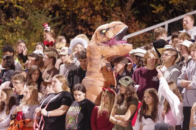 An orange Tyrannosaurus Rex was spotted among Newton football fans.