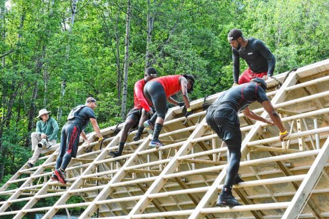 <b>Competitors climb over an obstacle during the 2024 Tri-State New Jersey Spartan Event Weekend on Aug. 10-11 at Mountain Creek in Vernon. (Photos by Maria Kovic)</b>