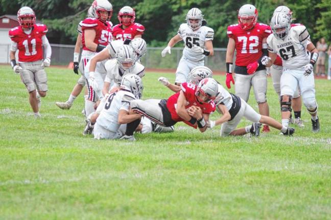 <b>High Point ball carrier Jerron Martress (15) is taken down by Wallkill Valley defenders. He rushed for 113 yards and scored two touchdowns.</b>