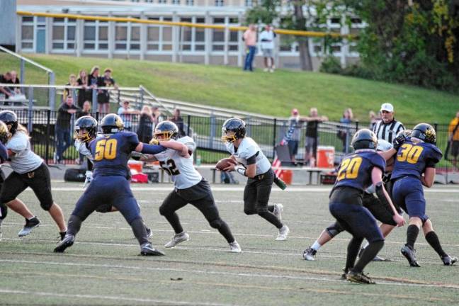 <b>FB3 West Milford quarterback Aydin Deane is on the move with the ball in the first half. He passed for 177 yards and rushed for three touchdowns.</b>