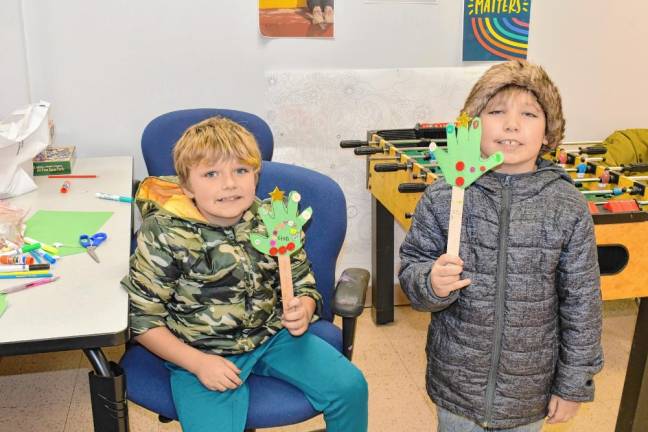 <b>Oliver Oczkowski and Karter Coursen make Christmas decorations.</b>