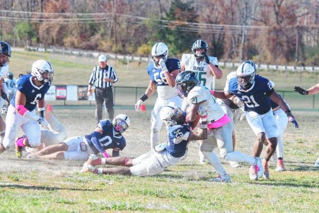 A Sussex County Community College defender gets his hands on a College of DuPage ball carrier in their game Oct. 26 at Sussex County Technical School in Sparta. The Skylanders lost, 58-21. (Photos by George Leroy Hunter)