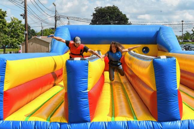 <b>Two people appear to be flying on this inflatable.</b>