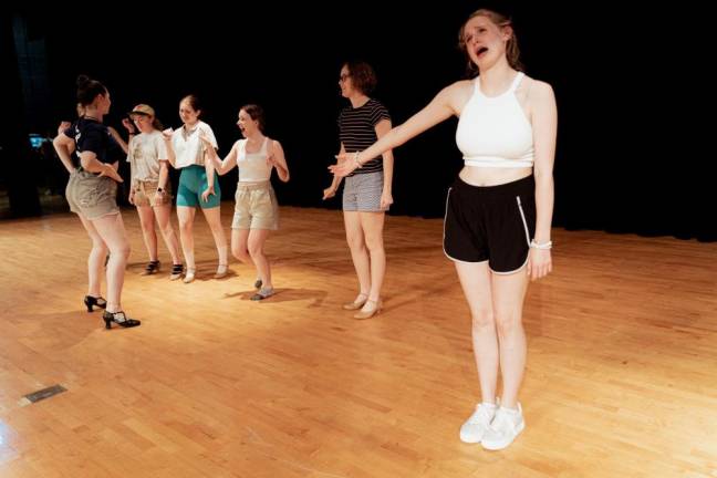 Ella Simmons, who plays Gertrude McFuzz, and cast members rehearse.