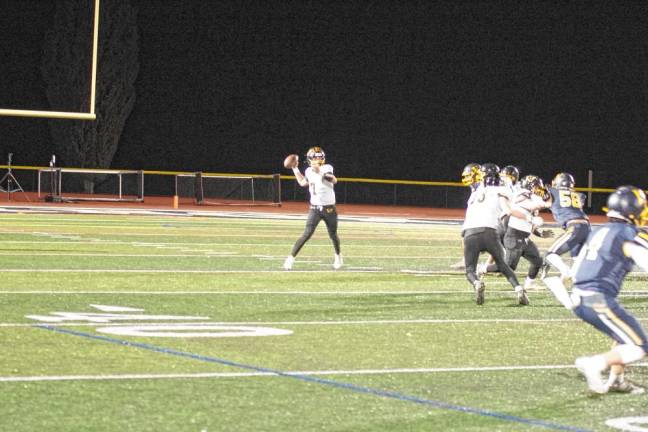 <b>West Milford quarterback Aydin Deane is about to throw the ball in the first half.</b>