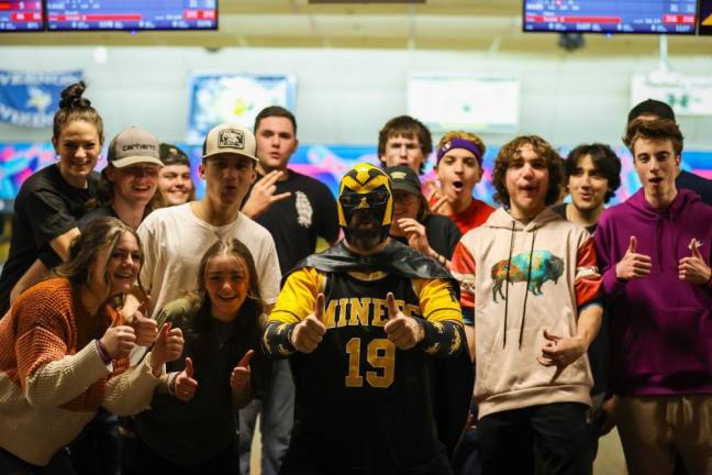 Miner Man, center, poses with high school students at the Bowl for Brandon fundraiser Jan. 23 at Sparta Lanes.