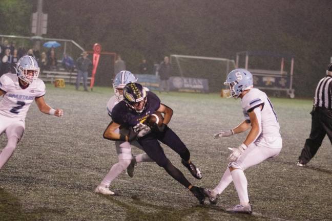 SP1 After catching the ball, Jefferson wide receiver Jeffrey Evans tries to break away from a Sparta defender. Evans caught a touchdown pass in the fourth quarter. (Photos by George Leroy Hunter)