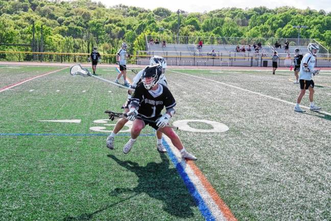 While in possession of the ball, Delaware Valley's Owen Kelly tries to outmaneuver a Vernon opponent.