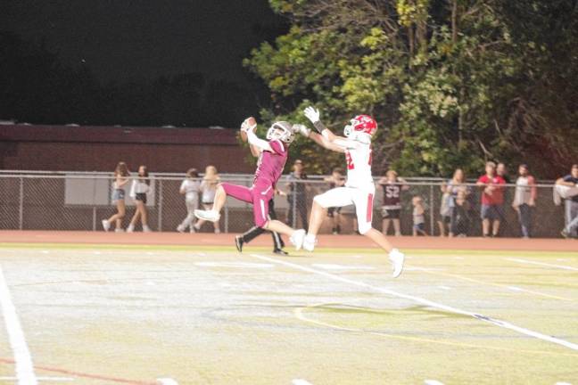 <b>Newton defensive back Hunter Wolfe intercepts the ball intended for Lenape Valley wideout Tyler Brennan in the first half.</b>