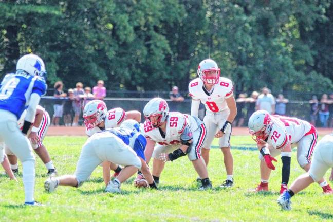 <b>High Point center Ryan Jaick (59) is in the ready position with the ball as quarterback John Elko (8) looks over the line before a play begins.</b>