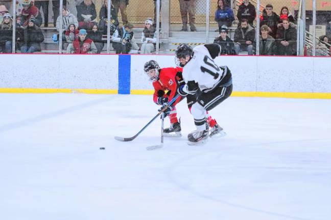 <b>Noah Krahling of the High Point/Wallkill Valley/Kittatinny tri-op ice hockey team and Matthew Hemenway of Parsippany Hills pursue the puck during their game Saturday, Dec. 14. The tri-op team won, 4-3. (Photos by George Leroy Hunter)</b>