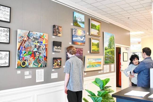 <b>FC1 Visitors look at the art on display in the Gallery at the Workspace during the grand opening June 1 of First Choice Workspace in Wantage. (Photos by Maria Kovic)</b>