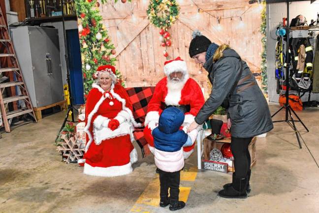 <b>Santa talks to a child after the annual tree lighting Friday, Dec. 6 in Vernon. (Photos by Maria Kovic)</b>