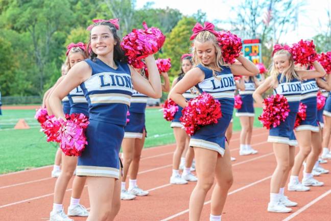 <b>Pope John senior Marissa Marston, left, and her cheer-squad mates on the sidelines. (Photo by Glenn Clark)</b>