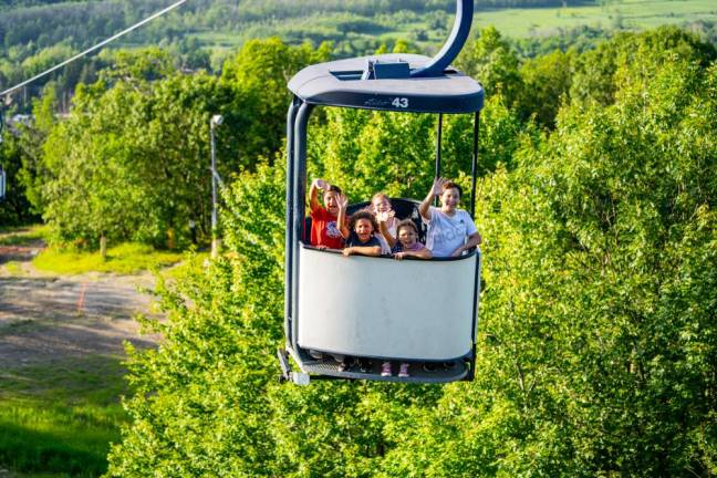 Visitors take a sky ride on the Cabriolet before the fireworks.