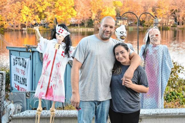 Joey Santiago with his wife, Kimberly Marquez, who has lived in the same home at the northern end of Clinton Road her entire life.. Twice she has seen the phantom car headlights at night.