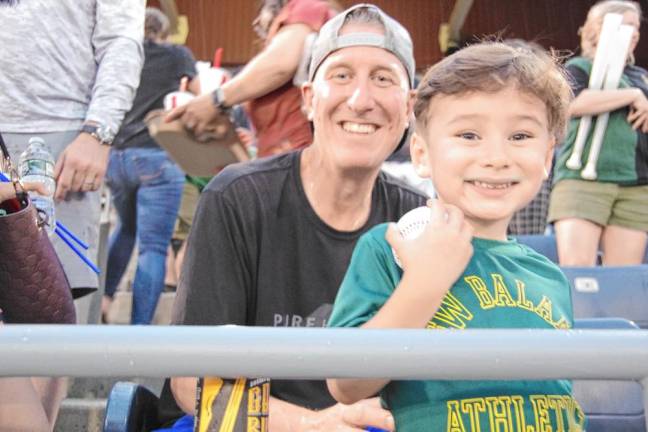 Michael Scott of Pequannock and Fitz Kissane, 3, of Kinnelon are all smiles while attending the Sussex County Miners game Saturday, June 29.