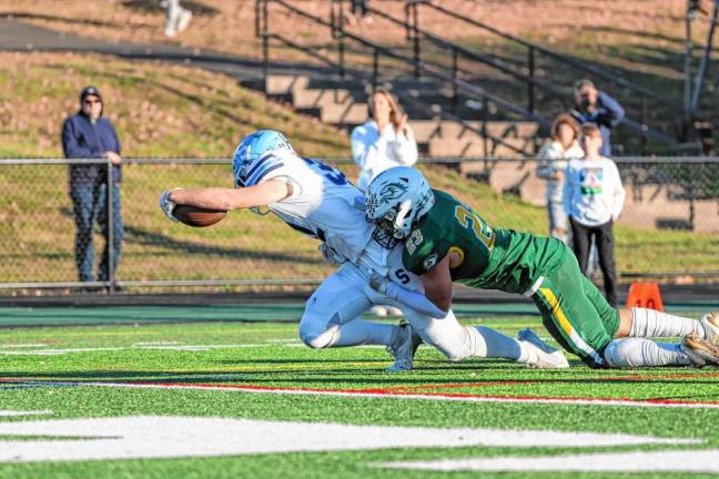 <b>Brady Shagawat of Sparta reaches out with the ball to score six points against Montville in the NJSIAA North Jersey, Section 1, Group 3 Tournament there Saturday, Nov. 2. Montville won, 20-6. (Photo by Glenn Clark) </b>