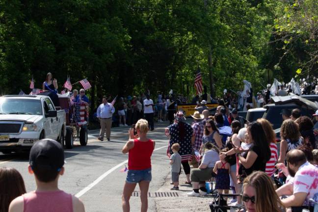 Crowds set up chairs along the parade route to cheer for veterans and others taking part in the parade.