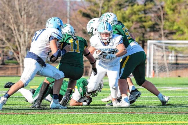 <b>Sparta running back Luke Brown emerges from Montville’s defensive line for a big first-quarter gain. (Photo by Glenn Clark)</b>