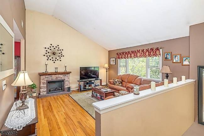 Fruit trees, pool, and gleaming hardwood floors are among this home’s amenities