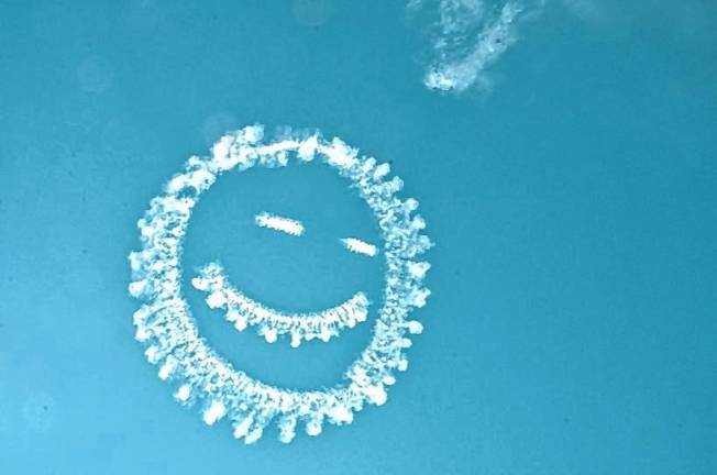 AIR4 A smiley face is created by smoke from a plane. (Photo by Ed Bailey)