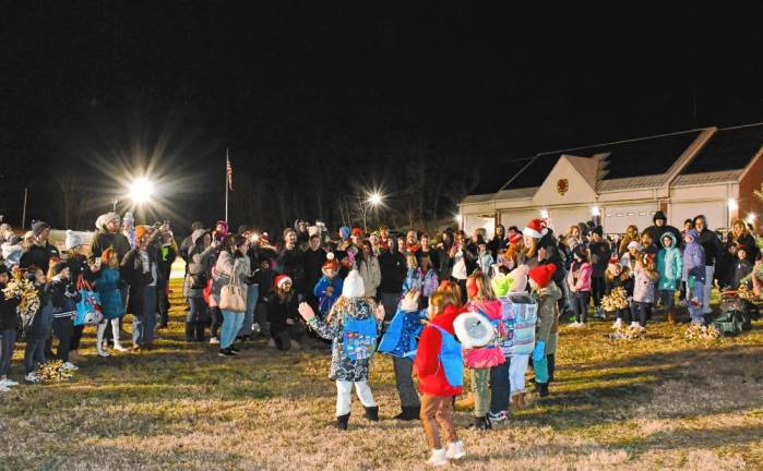 <b>The crowd watches a performance by young Girl Scouts.</b>