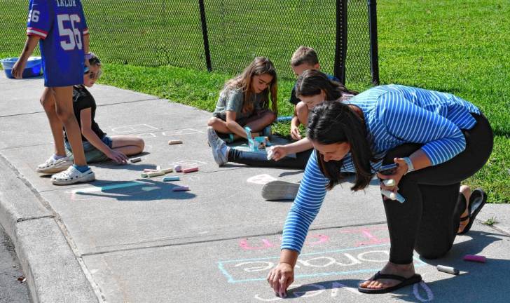 <b>CW2 Children and parents write messages in chalk Tuesday, Sept. 2 at Frankford Township School.</b>