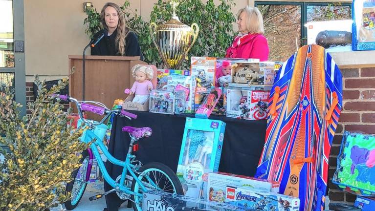 Cate Terwilliger of Selective Insurance Co. describes the company’s annual donations of children’s bicycles to the toy drive.