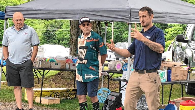 <b>Joshua Simmons, right, speaks at the official opening of Wantage’s disc golf course. From left are Deputy Mayor Ron Bassani and Dan Doyle. Simmons and Doyle designed the course.</b>