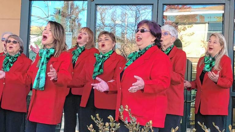 The a cappella group Harmony in Motion sings carols at the event.