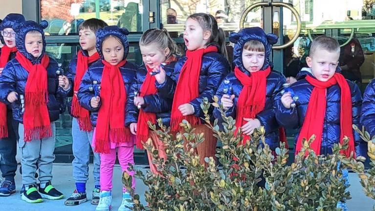 Students at Project Self-Sufficiency’s Little Sprouts Early Learning Center ring bells and sing a holiday song.