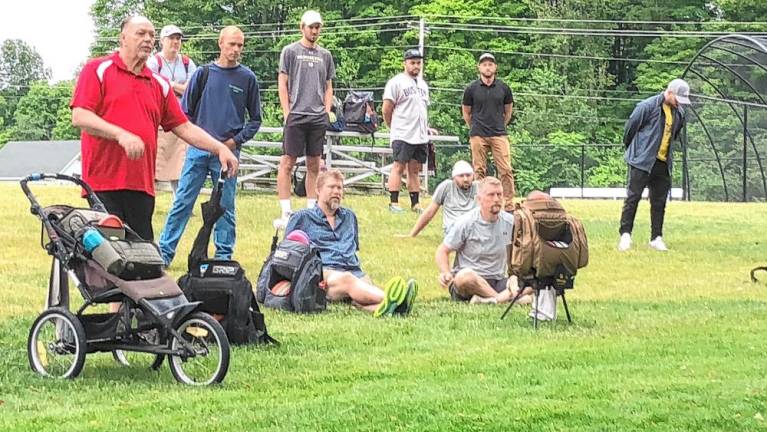 <b>Participants in the disc golf tournament listen to instructions.</b>