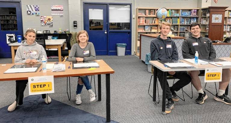 Students take the part of poll workers as part of the simulation. Those age 18 and older are eligible to be poll workers in a regular election. Several applied for a position. (Photo provided)