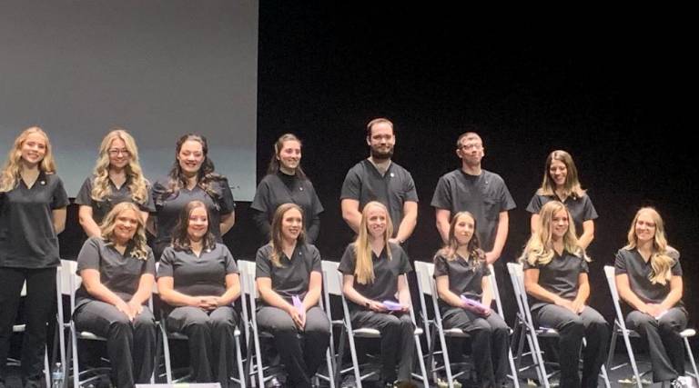 Sitting, from left, are Ashley Benecki, Kristin Smith, Kelly Kearns, Yuliia Baluk, Marilynn Aulov Vandertulip, Katheryn Szatkiewicz and Janie Sutton and standing, from left, are Chanelle Spivak, Natalia Lolo, Valentina Malanga, Leila Alliu, Christopher Rinkel, Michael Ireland and Meghan Decoite.