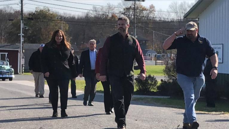 Sussex County Commissioner Bill Hayden, right, salutes as he passes the parade reviewing stand.